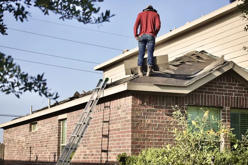 Professional roofer working on a residential roof in Vinmar Farms